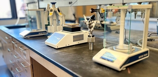 Two analytical balances, multichannel pipettes, and reaction vessels